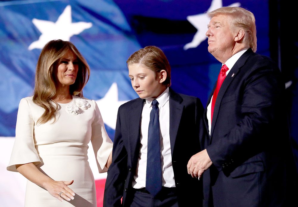Republican presidential candidate Donald Trump (R) embraces his son Barron Trump, as his wife Melania Trump looks on at the end of the Republican National Convention on July 21, 2016 at the Quicken Loans Arena in Cleveland, Ohio.