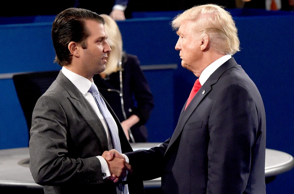 Donald Trump Jr. greets his father, Donald Trump, during the town hall debate at Washington University in St. Louis, Missouri, on October 9, 2016.
