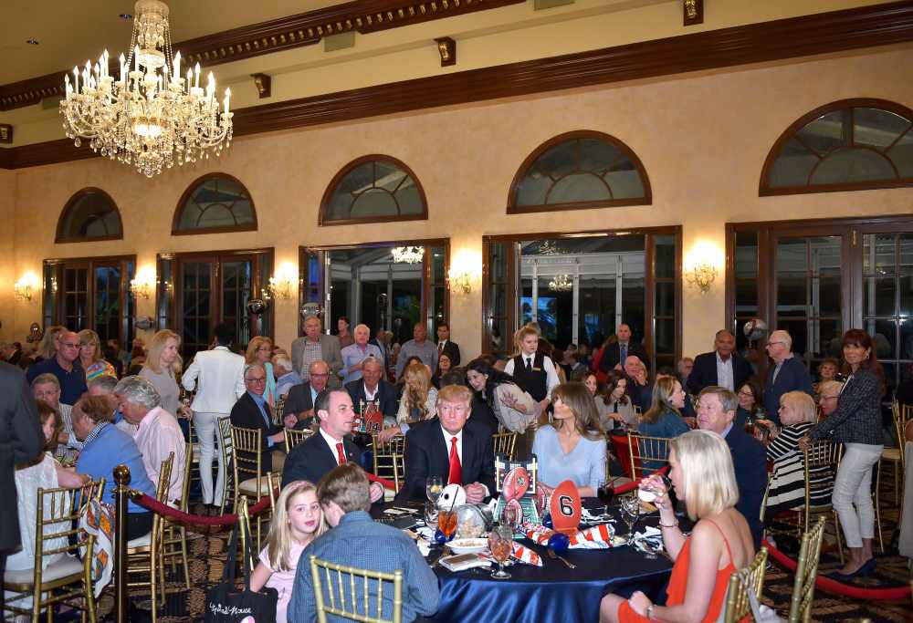 Donald Trump watches the Super Bowl with First Lady Melania Trump (R) and White House Chief of Staff Reince Priebus (L) at Trump International Golf Club Palm Beach in West Palm Beach, Florida on February 5, 2017.