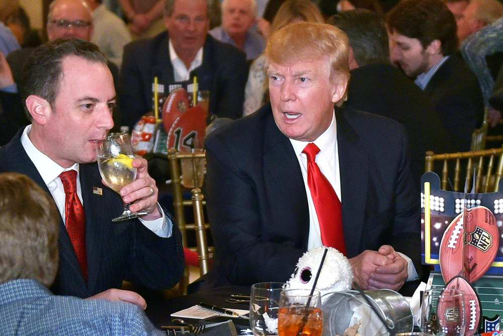 Donald Trump chats with White House Chief of Staff Reince Priebus while watching Super Bowl LI at Trump International Golf Club Palm Beach in West Palm Beach, Florida on February 5, 2017. /