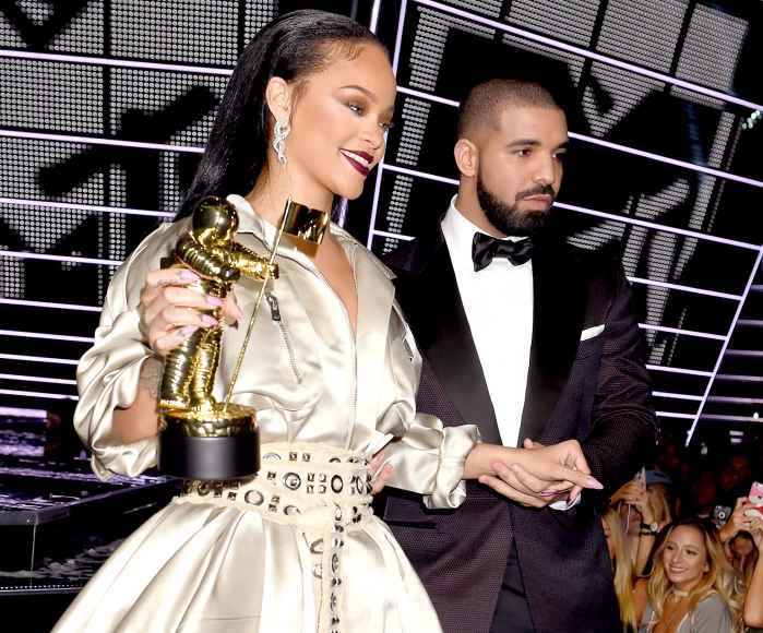 Rihanna accepts the Video Vanguard award from Drake onstage during the 2016 MTV Video Music Awards.