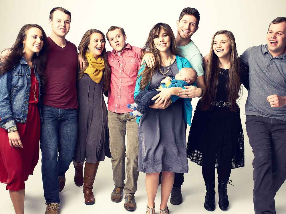 The Duggar family, from left to right: Jinger Duggar, Joseph Duggar, Jana Duggar, Josiah Duggar, Jessa (Duggar) Seewald holding Spurgeon Seewald, Ben Seewald, Joy Anna Duggar, John David Duggar.