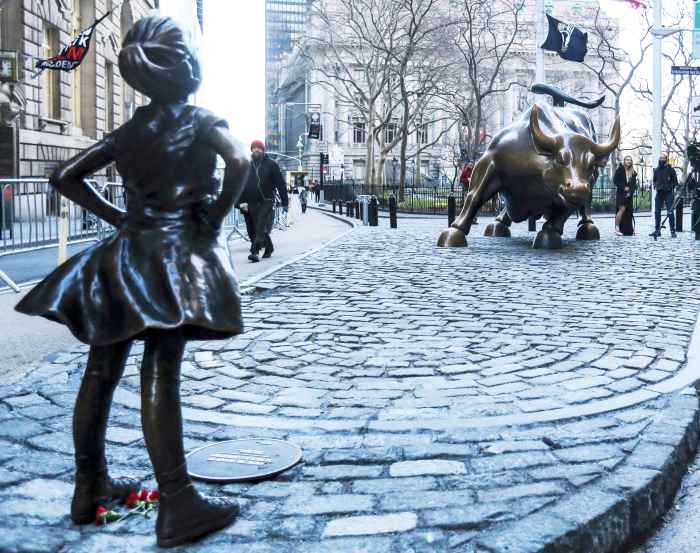 'The Fearless Girl' statue as it stands across from the Wall Street's famous Charging Bull