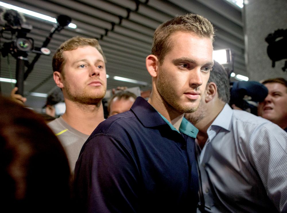 U.S Olympic swimmers Gunnar Bentz and Jack Conger leave the police headquarters at international departures of Rio de Janiero’s Galeo International airport on Aug. 18, 2016.