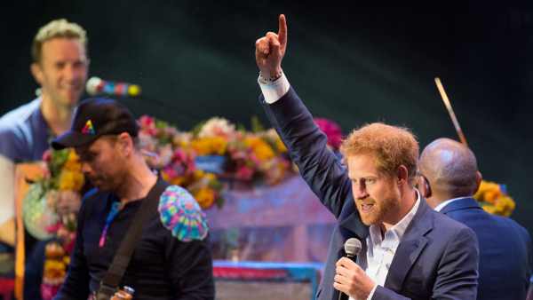 Prince Harry performs onstage with Coldplay