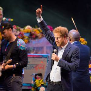 Prince Harry performs onstage with Coldplay