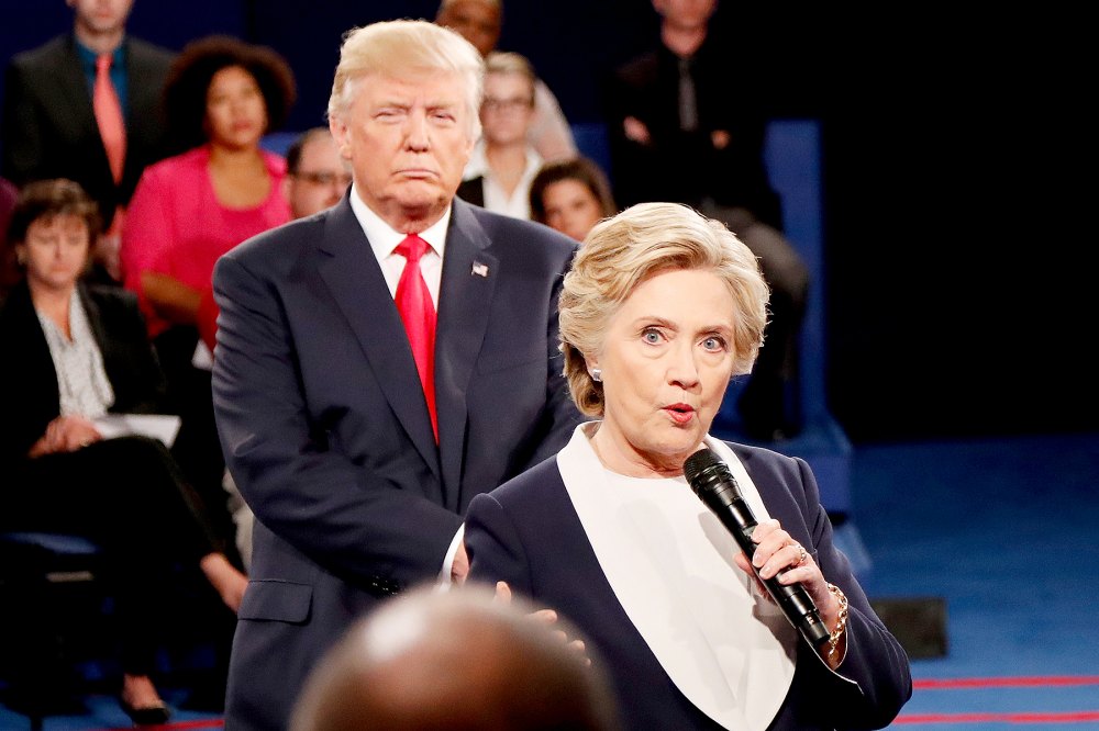 Democratic presidential nominee former Secretary of State Hillary Clinton (R) speaks as Republican presidential nominee Donald Trump looks on during the town hall debate at Washington University on October 9, 2016 in St Louis, Missouri.