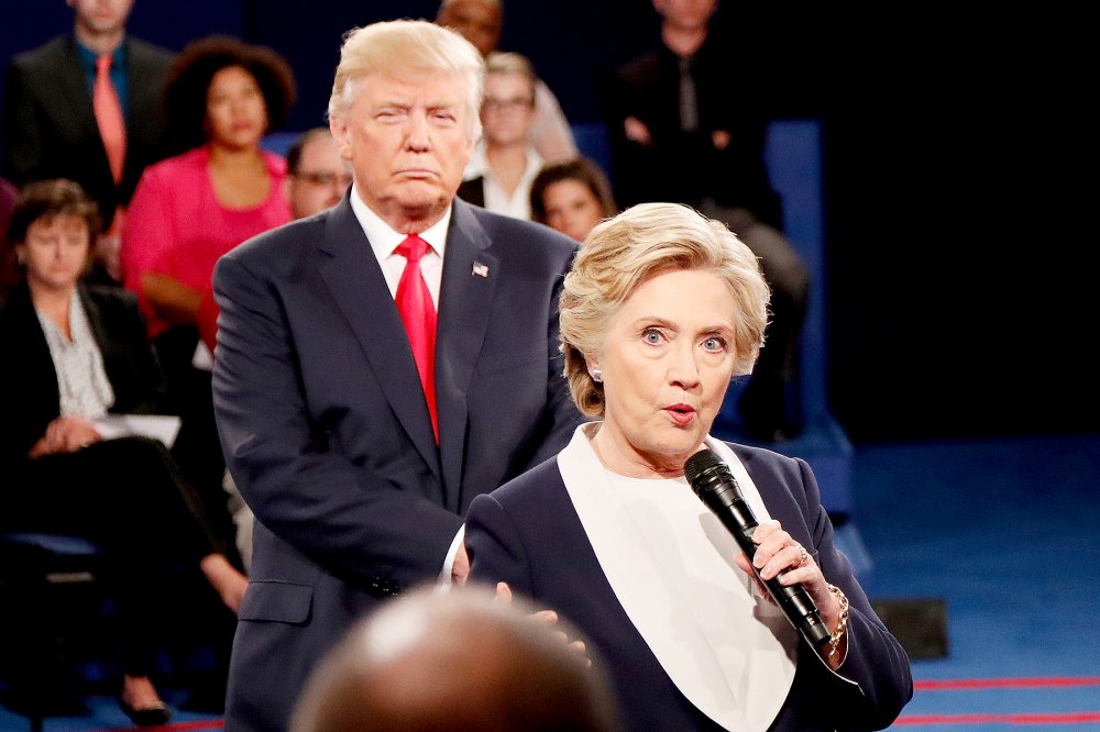 Democratic presidential nominee former Secretary of State Hillary Clinton (R) speaks as Republican presidential nominee Donald Trump looks on during the town hall debate at Washington University on October 9, 2016 in St Louis, Missouri.