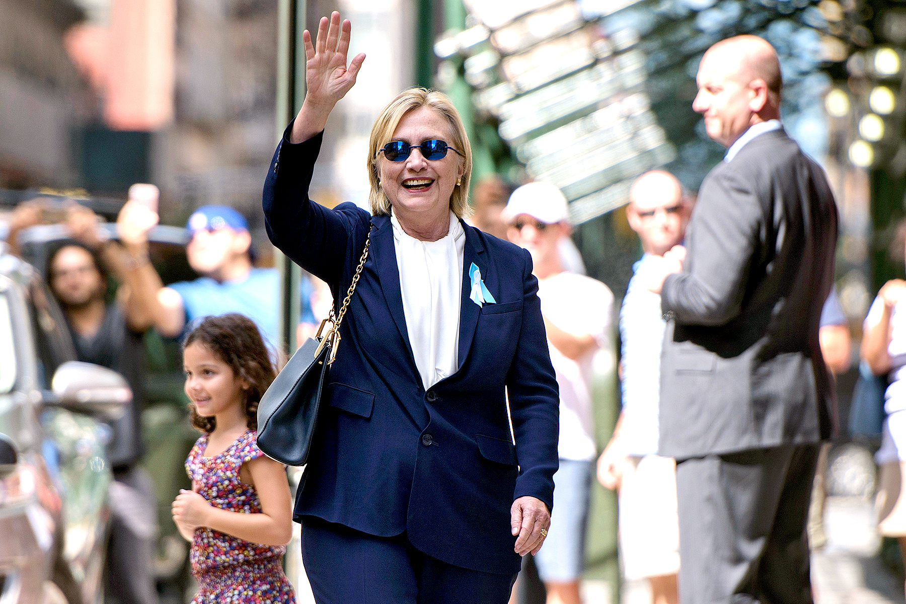 US Democratic presidential nominee Hillary Clinton waves to the press as she leaves her daughter's apartment building after resting on September 11, 2016, in New York. BRENDAN SMIALOWSKI/AFP/Getty Images
