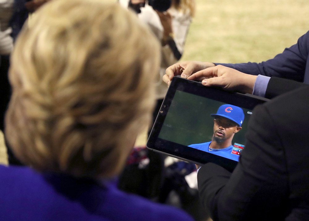 Democratic presidential candidate Hillary Clinton watches the World Series baseball game between the Chicago Cub and the Cleveland Indians after her final campaign rally of the day at Arizona State University in Tempe, Ariz., Wednesday, Nov. 2, 2016.