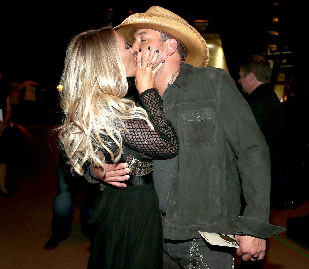Brittany Kerr and Jason Aldean, winner of the Entertainer of the Year award, kiss at the 51st Academy of Country Music Awards.