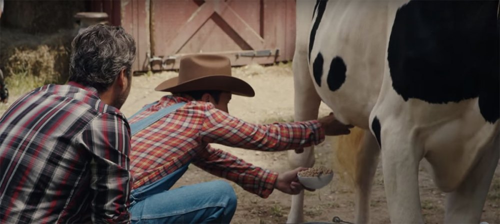 Jimmy Fallon tries to fill up his cereal bowl with some fresh milk as Blake Shelton watches on