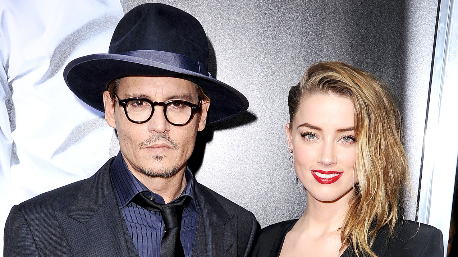 Johnny Depp and Amber Heard arrives at the "3 Days To Kill" at ArcLight Cinemas on February 12, 2014 in Hollywood, California.