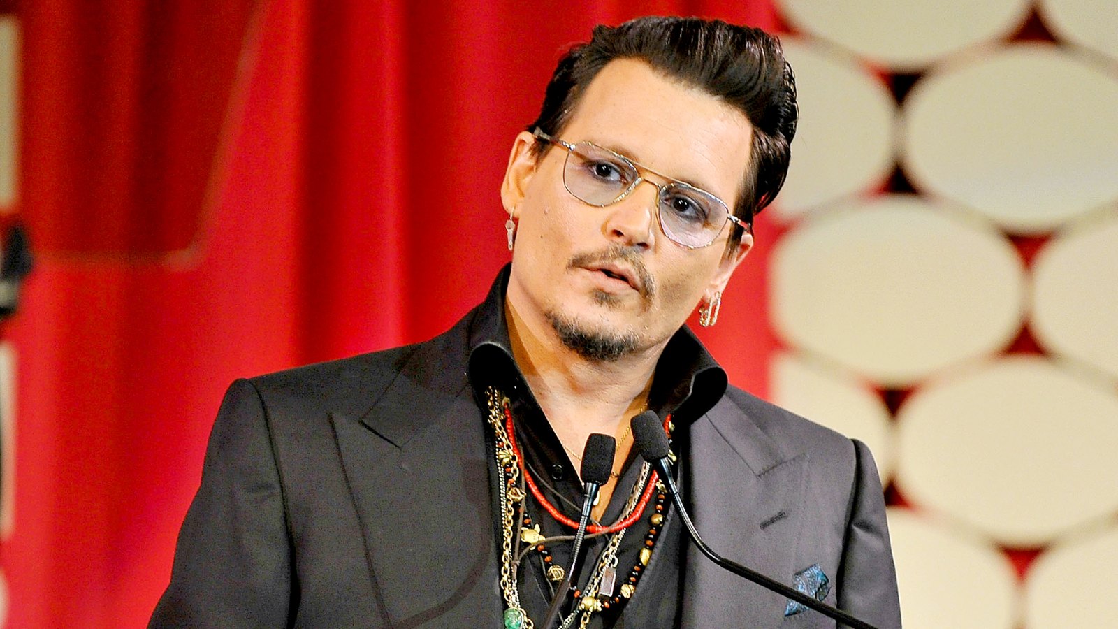 Johnny Depp on stage at the Make-Up Artists and Hair Stylists Guild Awards at Paramount Studios on February 20, 2016 in Hollywood, California.