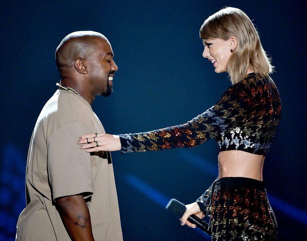 Recording artist Kanye West accepts the Video Vanguard Award from Taylor Swift onstage during the 2015 MTV Video Music Awards.