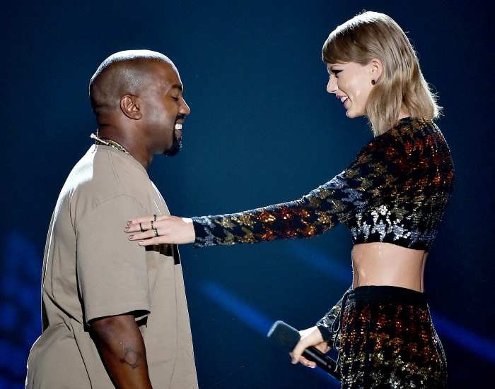 Recording artist Kanye West accepts the Video Vanguard Award from Taylor Swift onstage during the 2015 MTV Video Music Awards.