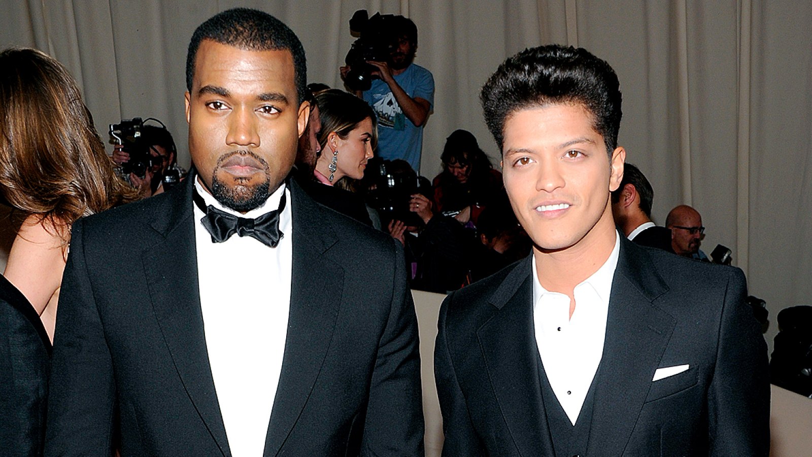 Kanye West, left, and Bruno Mars arrive at the Metropolitan Museum of Art Costume Institute gala benefit, celebrating the 'Alexander McQueen: Savage Beauty' exhibition, Monday, May 2, 2011 in New York.