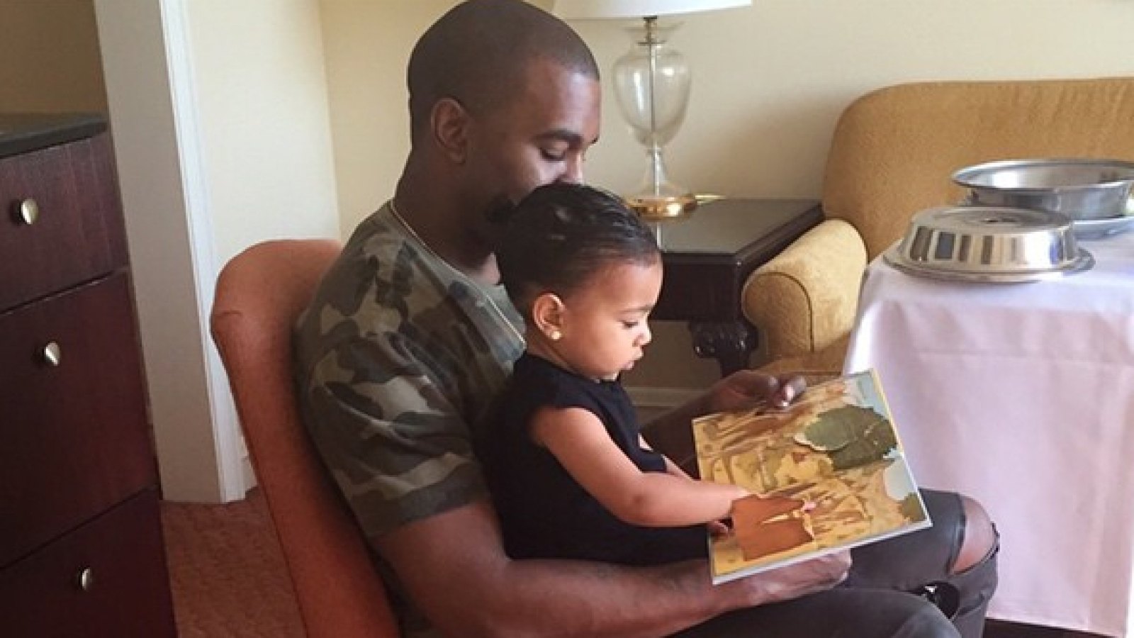 Kanye West reads to North West