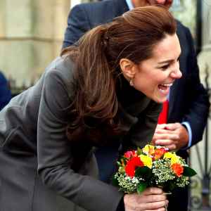 Kate Middleton receives a bunch of flowers from Theo Hayward aged three, as she leaves after visiting a GISDA centre during a visit to Caernarfon on November 20, 2015 in Wales.