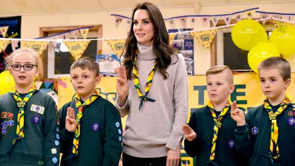 Britain's Catherine, Duchess of Cambridge (C), reads the Scouts promise during a Cub Scout Pack meeting with cubs from the Kings Lynn District, in Kings Lynn, eastern England, on December 14, 2016, to celebrate 100 years of Cubs. The Duchess attended a special Cub Scout Pack meeting with Cubs from the Kings Lynn District to celebrate 100 years of Cubs. Cub Scouting was co-founded by Robert Baden-Powell and Vera Barclay on the 16th December 1916.