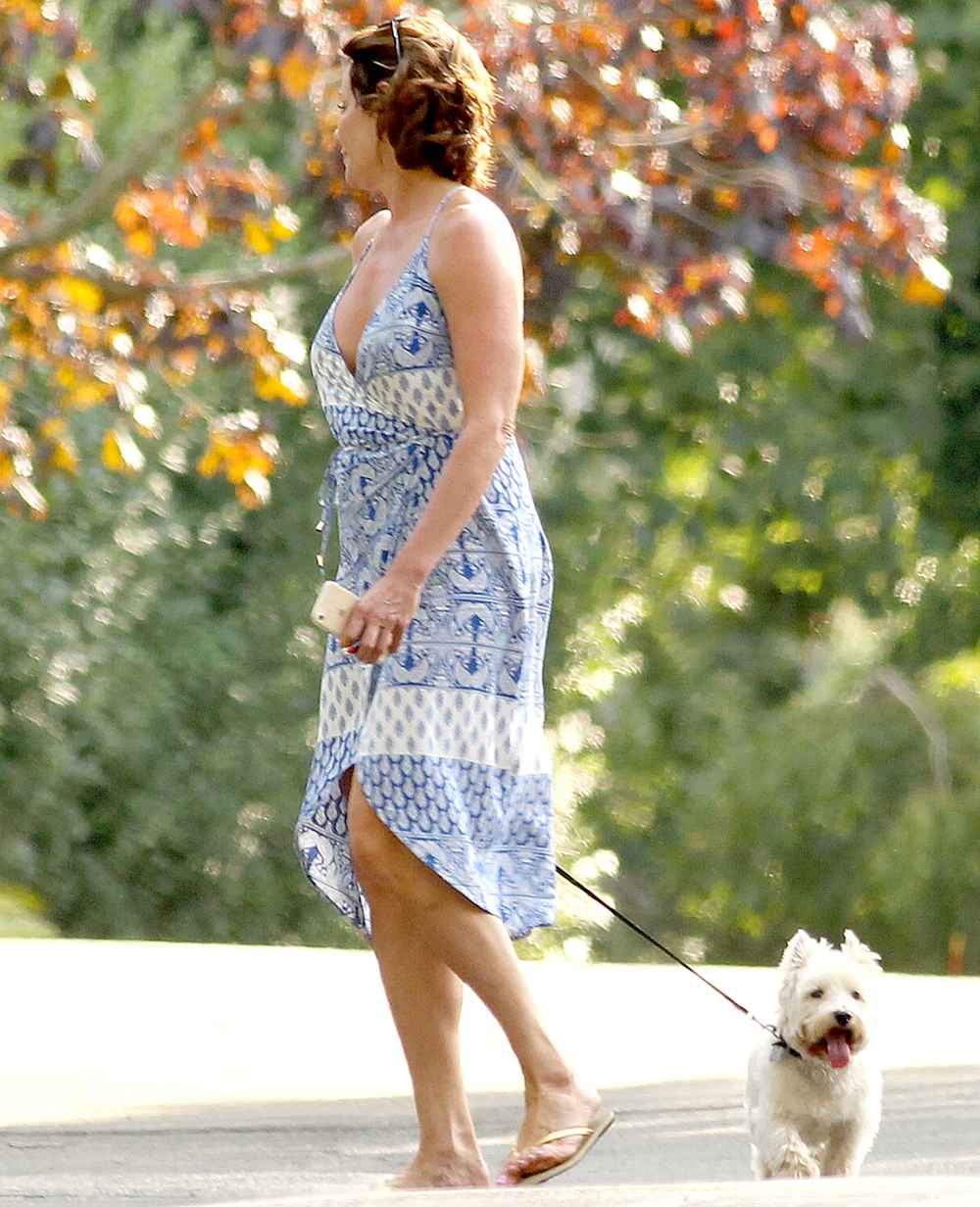 Countess Luann De Lesseps walking her dog with a friend in the Hamptons on August 23, 2017. MATT AGUDO/INSTARimages.com