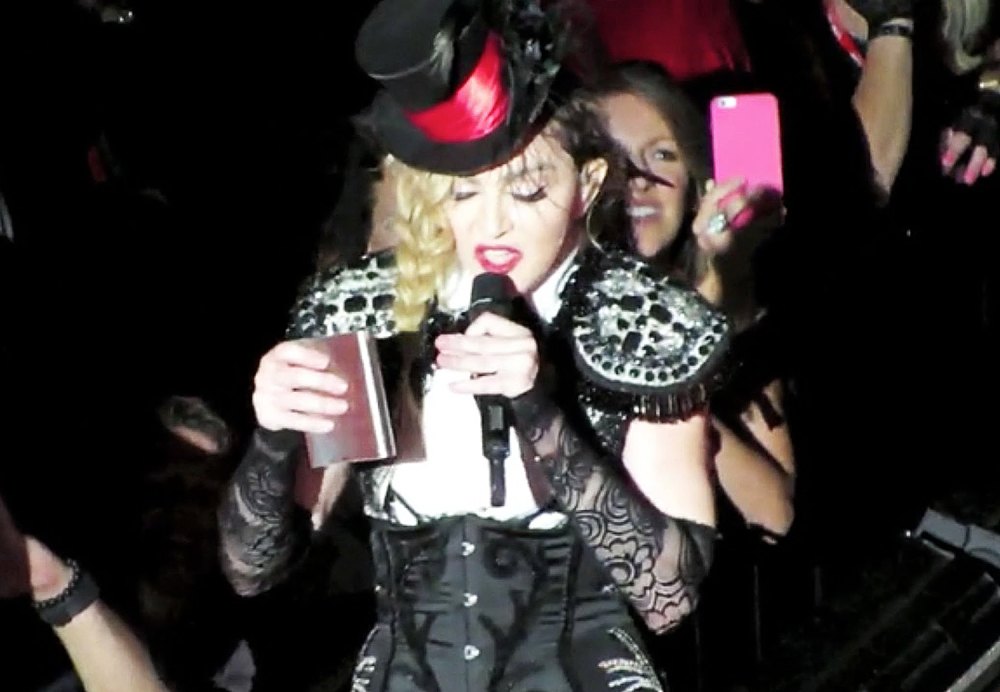 Madonna onstage with a flask