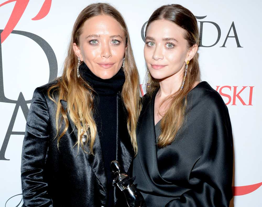 Mary-Kate Olsen and Ashley Olsen pose backstage at the 2015 CFDA Fashion Awards.