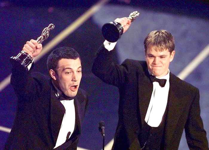 Ben Affleck (L) and Matt Damon hold up their Oscars after winning in the Original Screenplay Category during the 70th Academy Awards at the Shrine Auditorium 23 March. The two won for their Original Screenplay "Good Will Hunting."