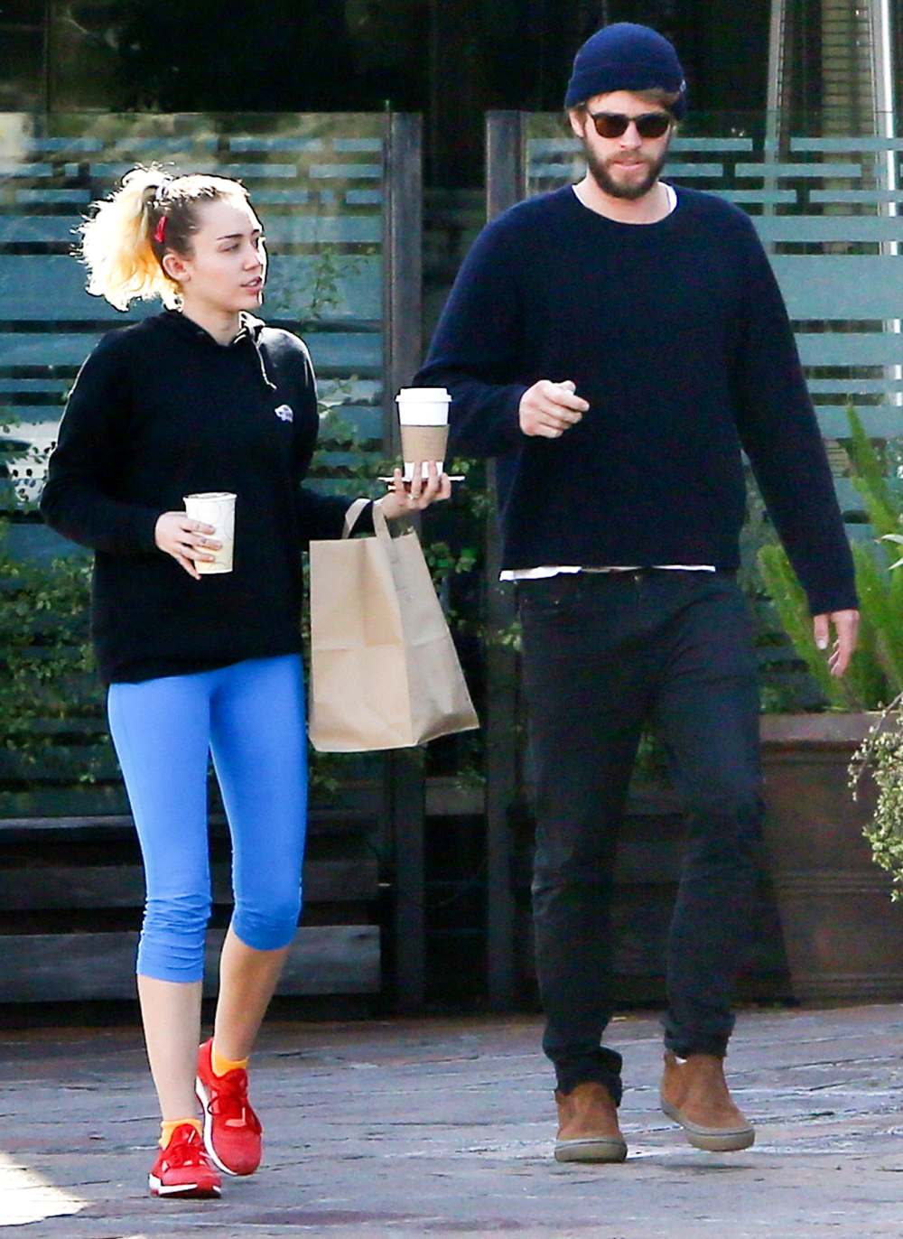 Miley Cyrus and Liam Hemsworth exit Ollo restaurant in Malibu with some friends following lunch.