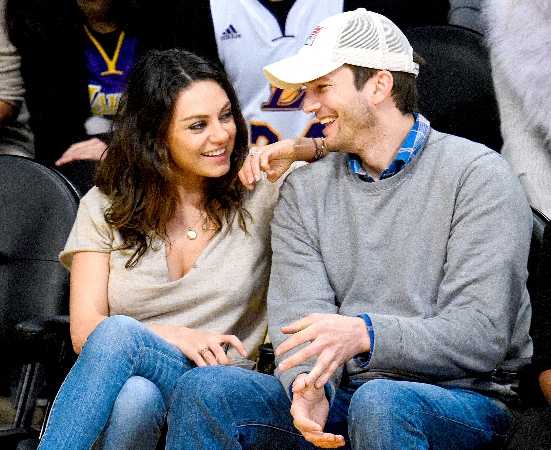 Mila Kunis and Ashton Kutcher attend a basketball game between the Oklahoma City Thunder and the Los Angeles Lakers at Staples Center in Los Angeles on December 19, 2014.