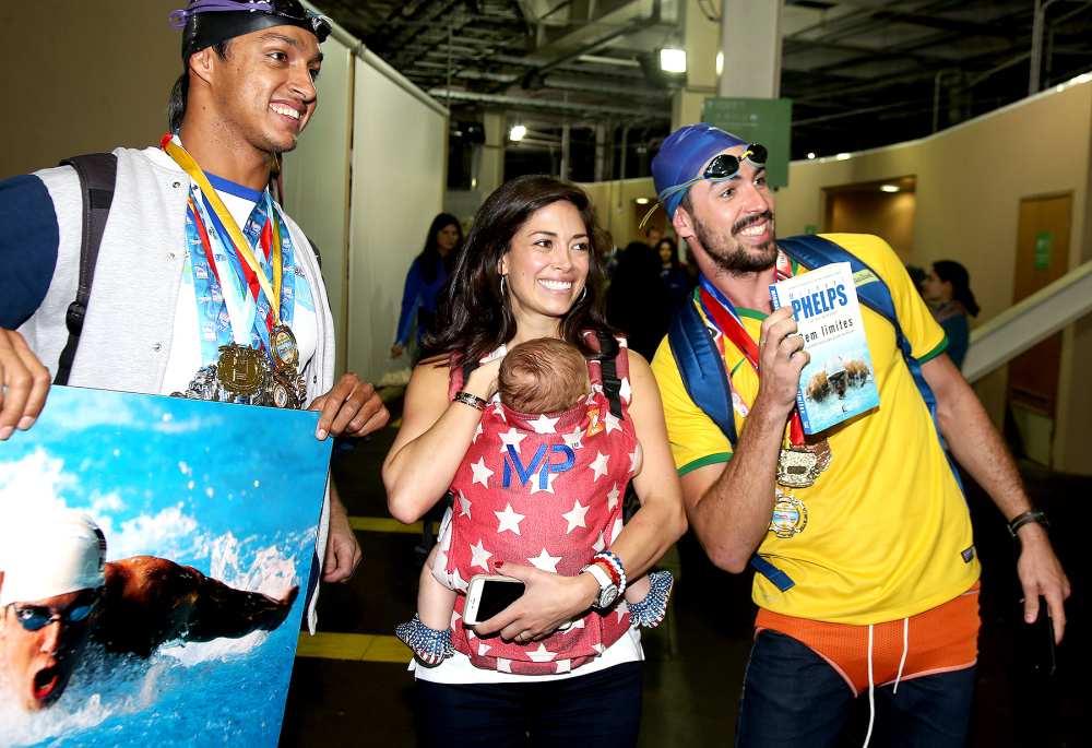 Nicole Johnson, fiancée of Michael Phelps, holding their baby son Boomer Phelps pose with fans of Phelps on day 8 of the Rio 2016 Olympic Games at Olympic Aquatics Stadium on August 13, 2016 in Rio de Janeiro, Brazil.