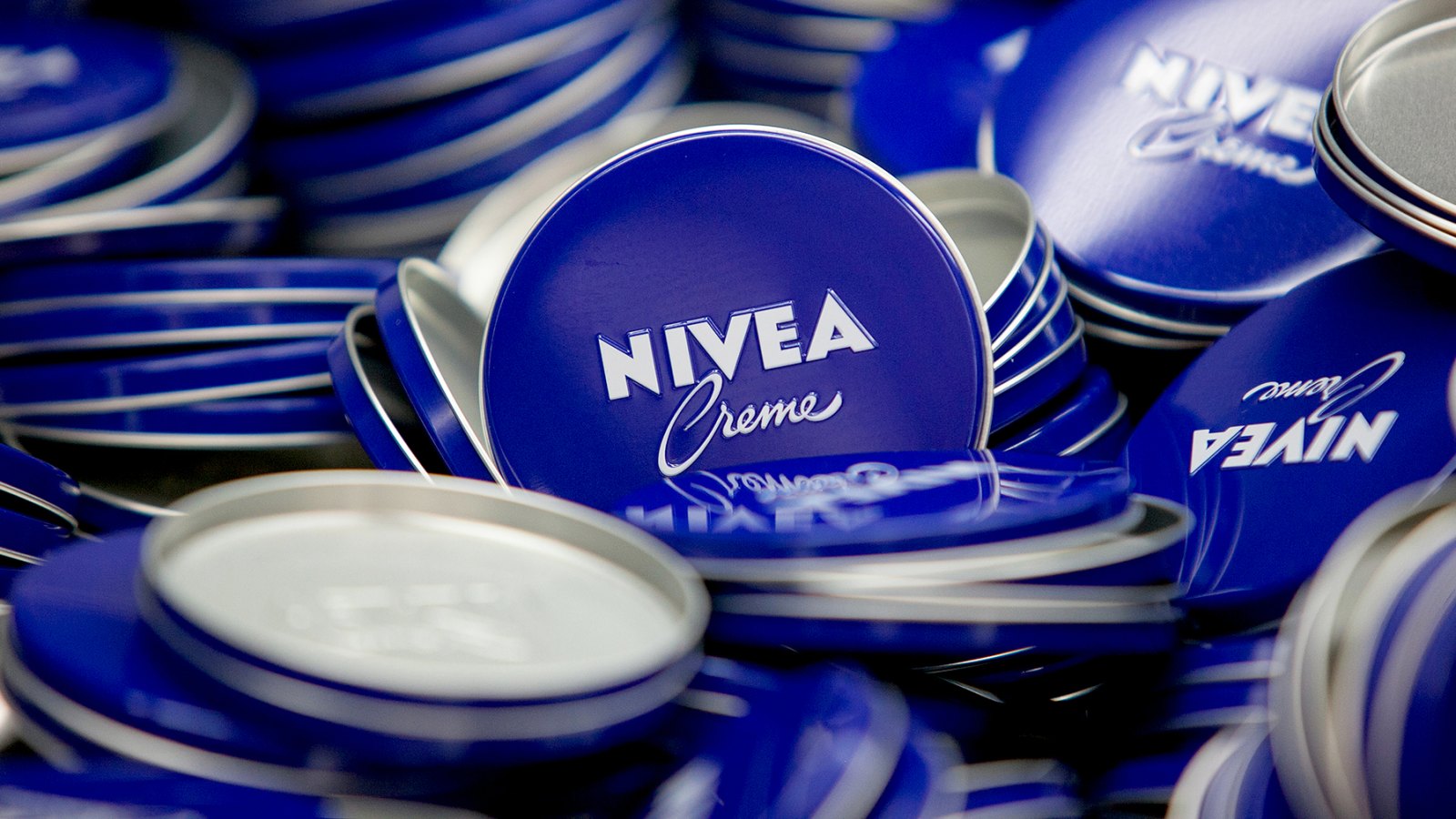 Lids of Nivea Creme skin care lotion tins sit in the production center at the headquarters of Beiersdorf AG in Hamburg, Germany, on Thursday, Feb. 12, 2015.