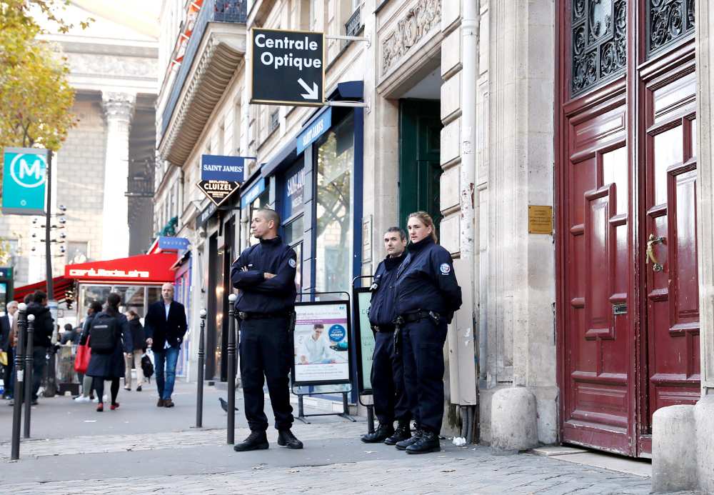 Police officers stand guard at the entrance to a hotel residence at the Rue Tronchet, near Madeleine, central Paris, on October 3, 2016, where US reality television star Kim Kardashian was robbed at gunpoint by assailants disguised as police.