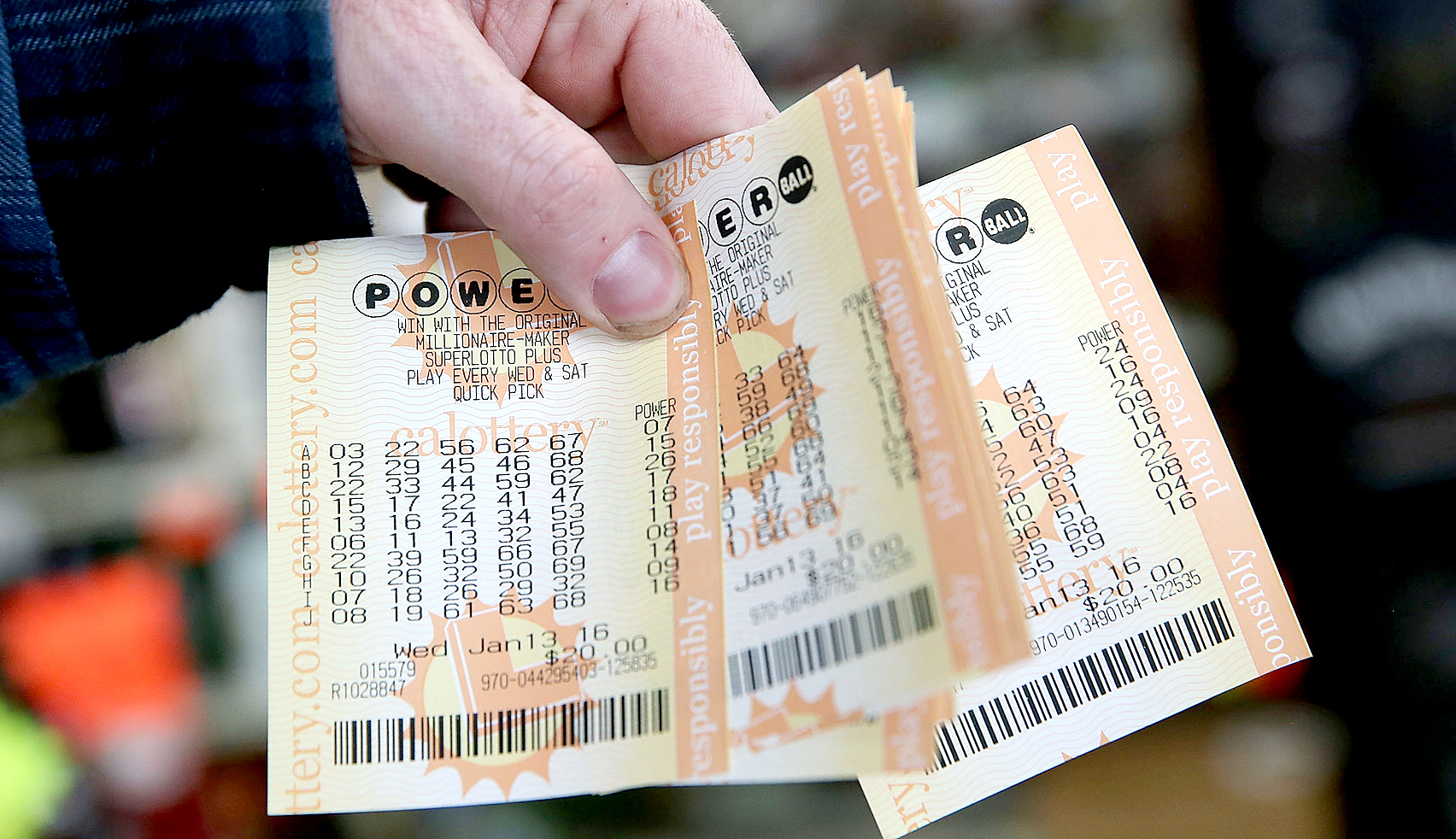 A customer holds a handful of Powerball tickets at Kavanagh Liquors on January 13, 2016 in San Lorenzo, California.