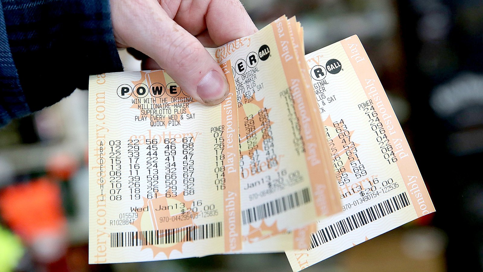 A customer holds a handful of Powerball tickets at Kavanagh Liquors on January 13, 2016 in San Lorenzo, California.