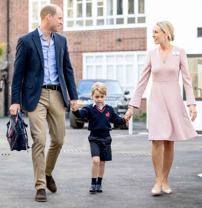 Prince George accompanied by Britain's Prince William, Duke of Cambridge arrives for his first day of school at Thomas's school where he is met by Helen Haslem (R) head of the lower school on September 7, 2017 in southwest London.