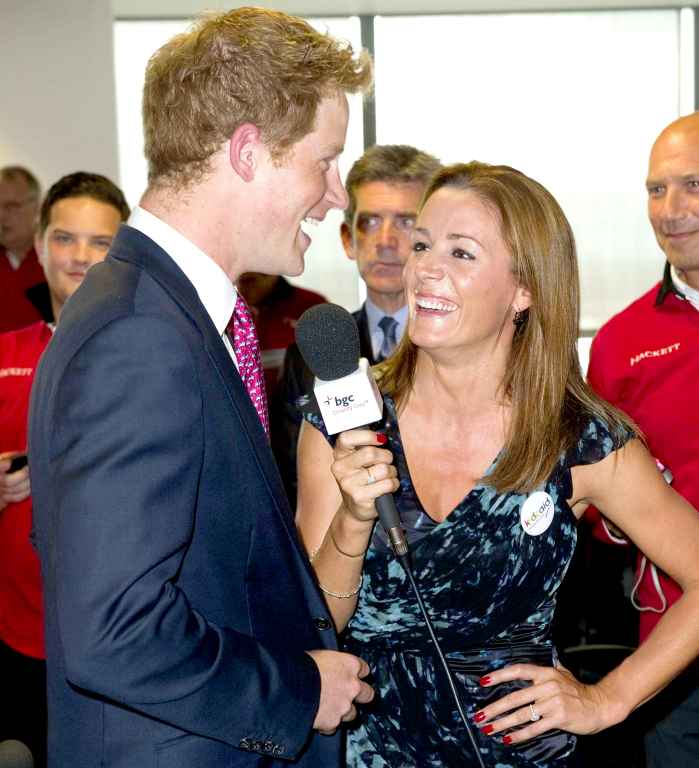Britain's Prince Harry talks to British TV and radio presenter Natalie Pinkham on the trading floor as he attends BGC Partners' Charity Day in London, on September 12, 2011.