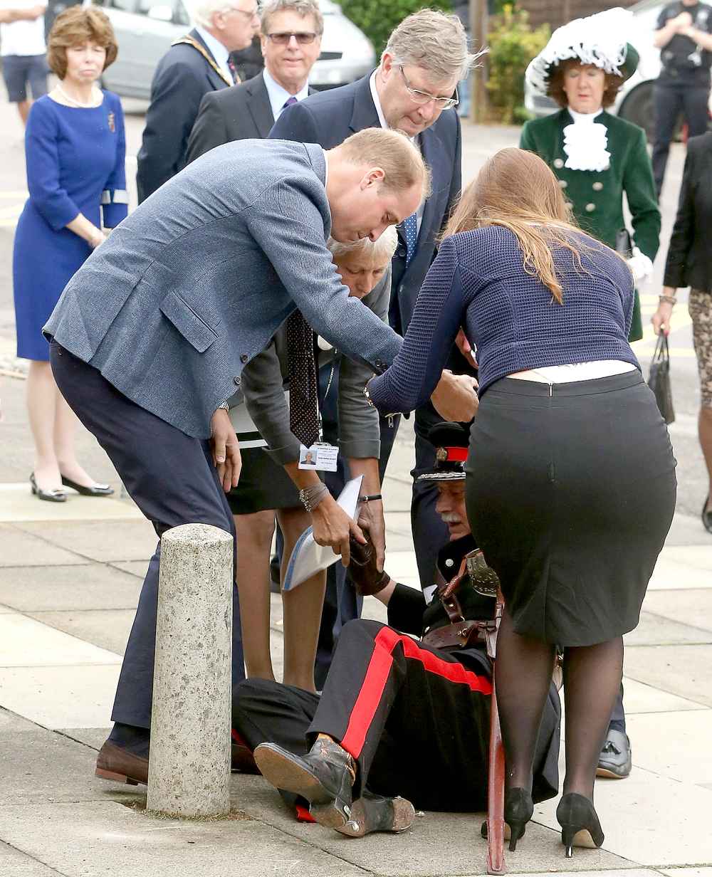 Prince William, Duke of Cambridge rushes to help Vice Lord Lieutenant of Essex Jonathon Douglas-Hughes who fell backwards over a bollard as they arrive at Steward's Academy on September 16, 2016 in Harlow, England.