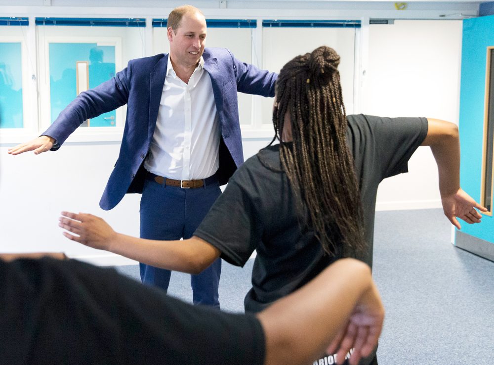 Prince William learns a dance move with Scariofunk dance collective during a visit to Caius House Youth Centre in London on September 14, 2016.