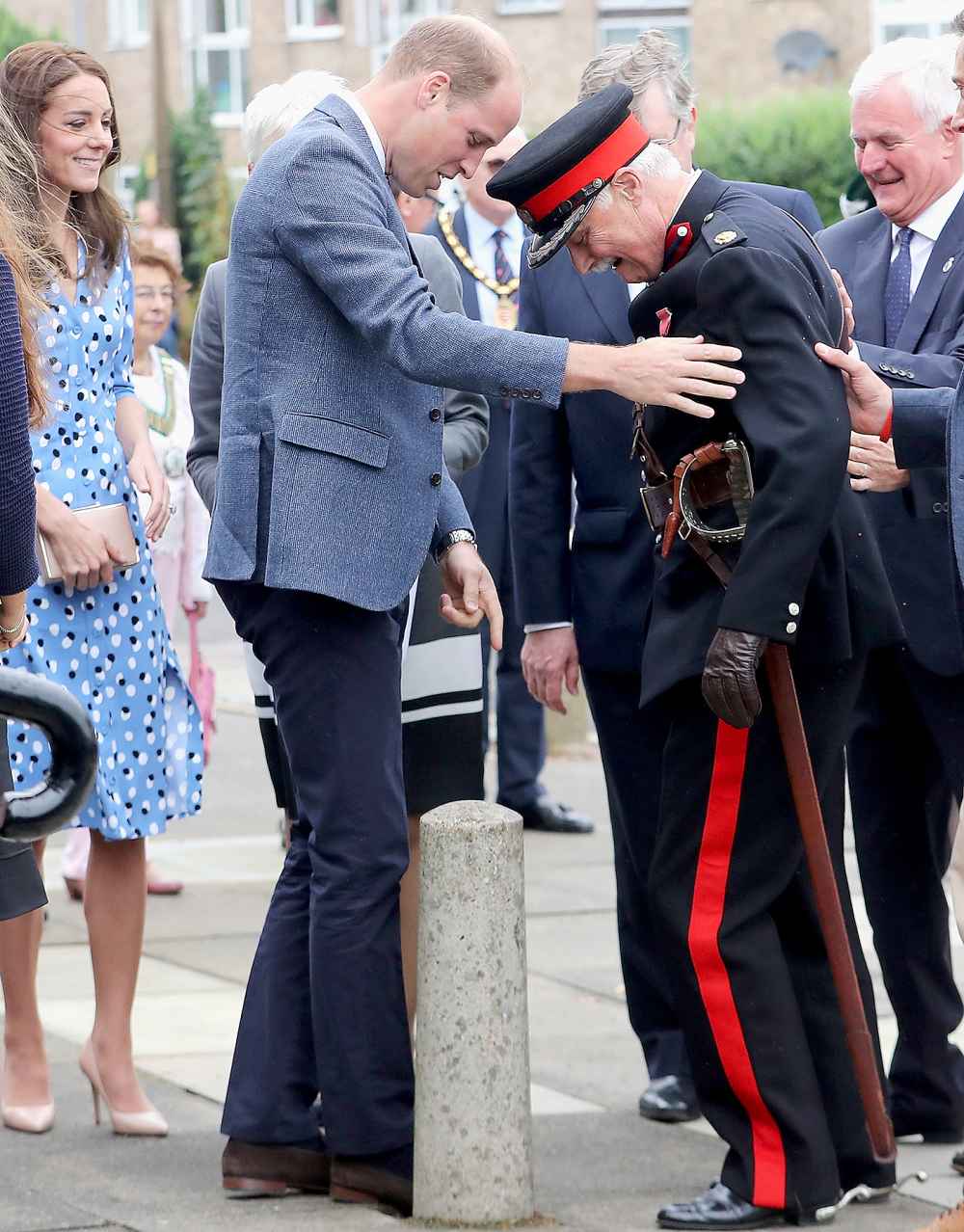 Catherine, Duchess of Cambridge looks on as Prince William, Duke of Cambridge rushes to helpVice Lord Lieutenant of Essex Jonathon Douglas-Hughes who fell backwards over a bollard as they arrive at Steward's Academy on September 16, 2016 in Harlow, England.