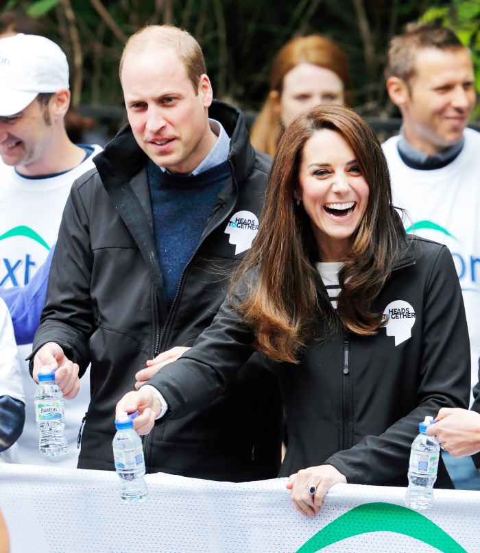 Prince William, Duke of Cambridge & Catherine, Duchess of Cambridge hand out water to runners taking part in the 2017 Virgin Money London Marathon on April 23, 2017 in London, England.