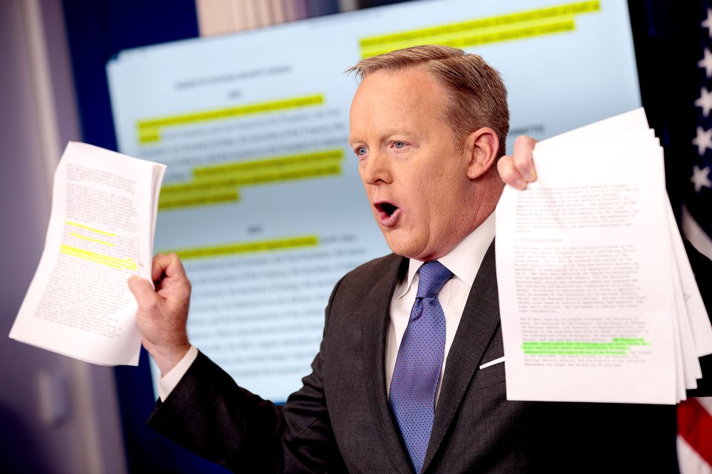 White House Press Secretary Sean Spicer holds up paperwork highlighting and comparing language about the National Security Council from the Trump administration and previous administrations during the daily press briefing at the White House, January 30, 2017 in Washington, DC.