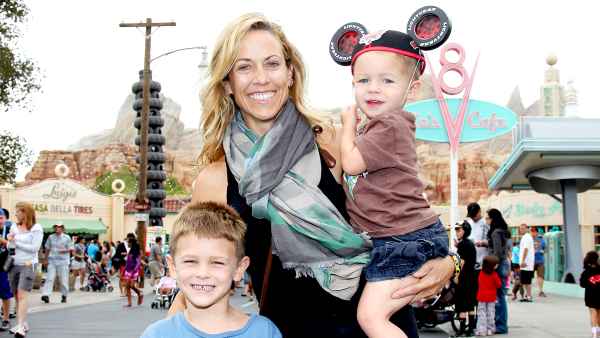Sheryl Crow and her sons, Wyatt, 5 (left) and Levi, 2, pose at Cars Land in Disney California Adventure park on July 25, 2012 in Anaheim, California.