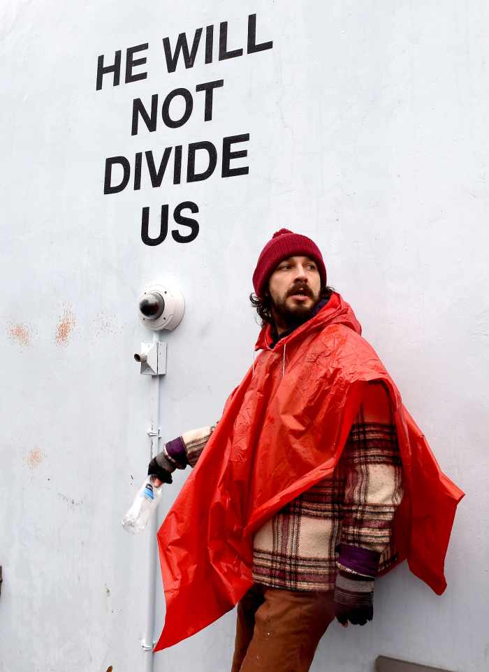 US actor Shia LaBeouf(L)is seen during his He Will Not Divide Us livestream outside the Museum of the Moving Image in Astoria, in the Queens borough of New York January 24, 2017 as a protest against President Donald Trump.