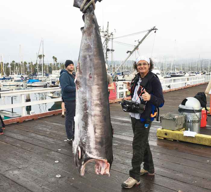 Longtime collaborator and producer/director Chris Marino stands next to a 400-pound swordfish caught during the episode.