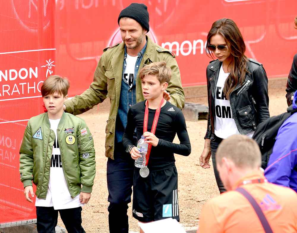 Cruz Beckham, David Beckham and Victoria Beckham congratulate Romeo Beckham after he finished the Childrns Marathon during the London Marathon on April 26, 2015 in London, England.