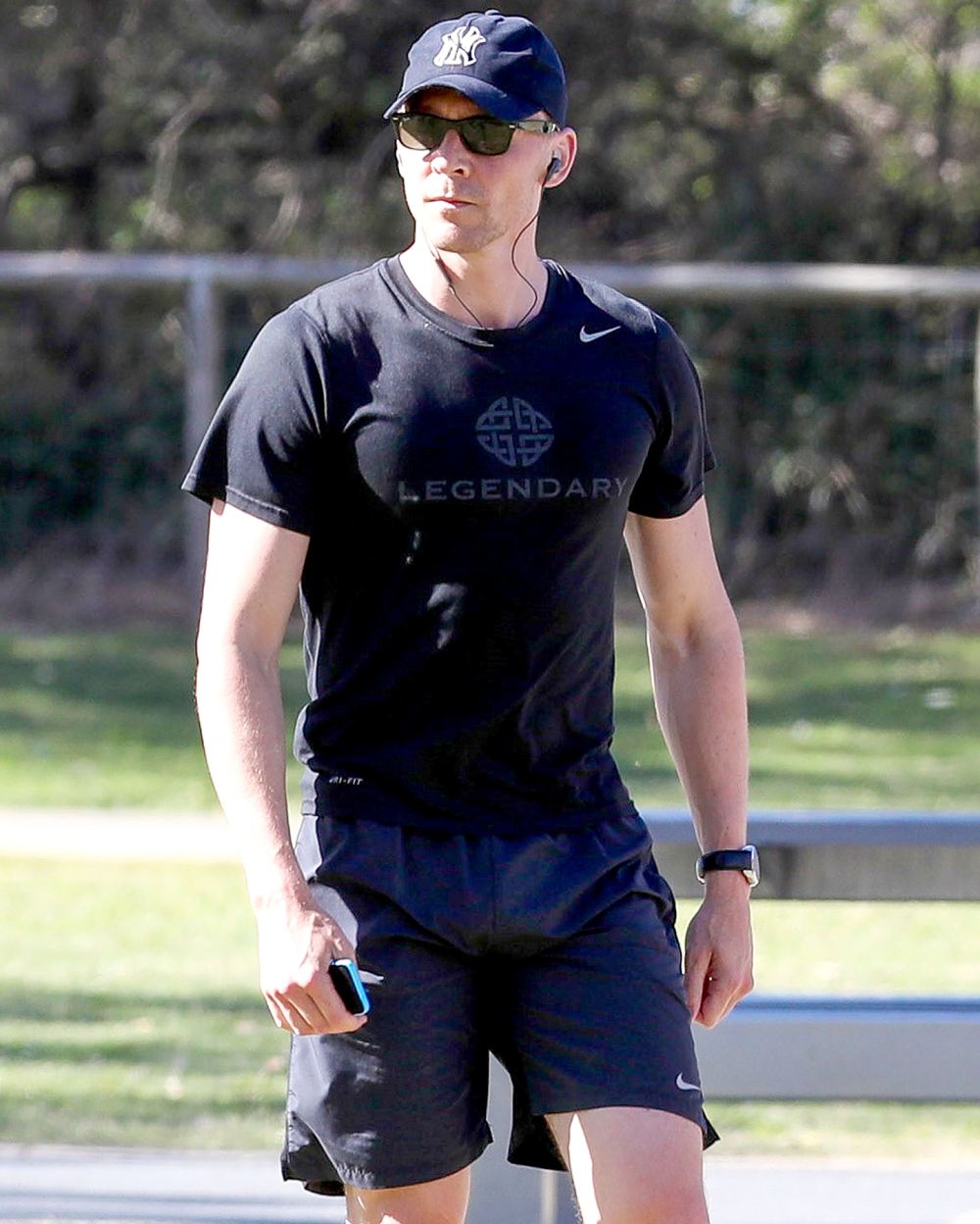 Tom Hiddleston heads back to his hotel to girlfriend Taylor Swift after a jog with his trainer on Broad Beach.