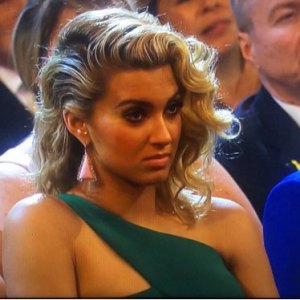 Tori Kelly looks unimpressed during Taylor Swift's Grammys 2016 speech