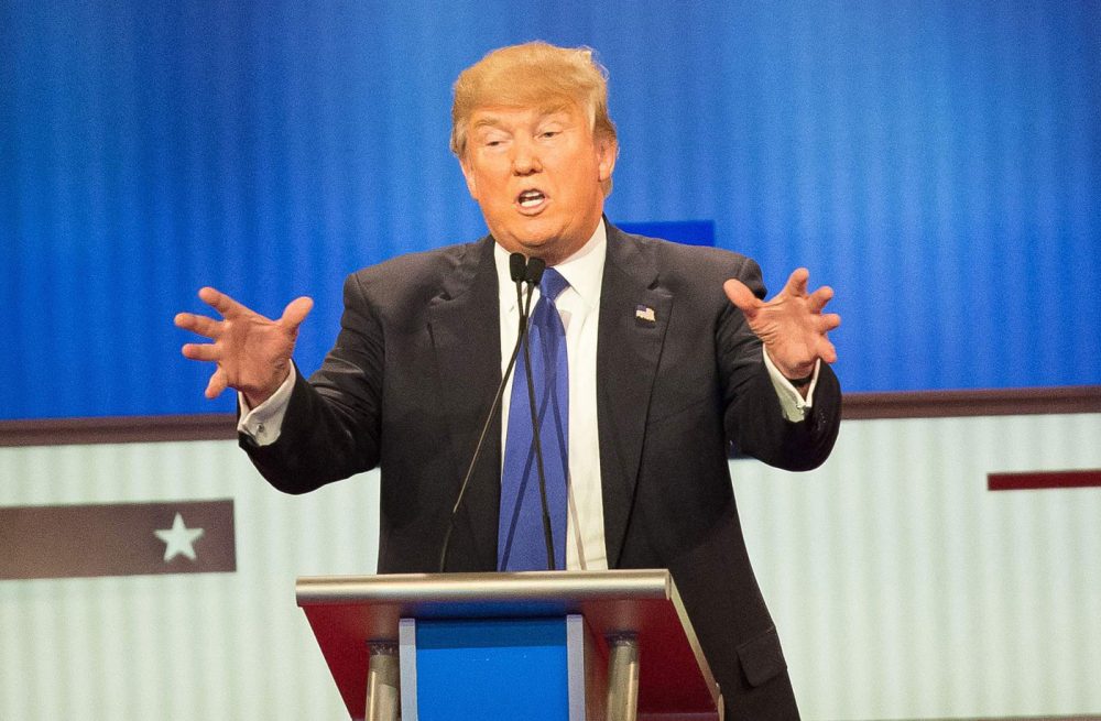 Republican Presidential candidate Donald Trump (C) responds to a point during the Republican Presidential Debate in Detroit, Michigan