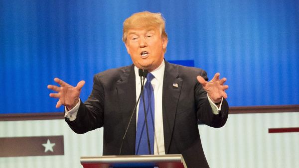 Republican Presidential candidate Donald Trump (C) responds to a point during the Republican Presidential Debate in Detroit, Michigan